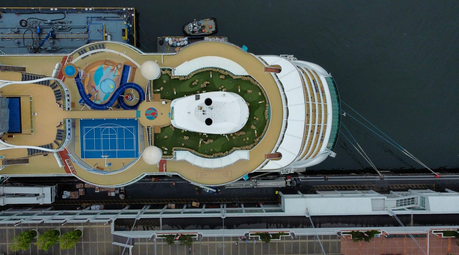 Aerial view of a large cruise ship alongside a port terminal
